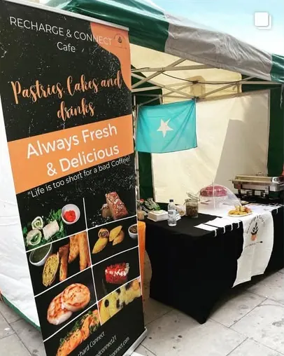 The Recharge & Connect market stall at Chatsworth Road Market, with a banner reading Always Fresh and Delicious