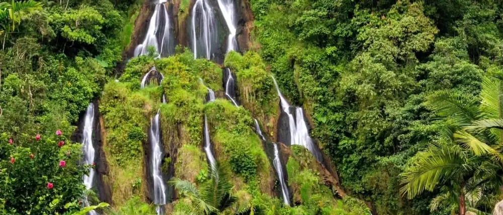 A waterfall pouring down a green Colombian hillside